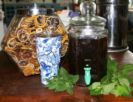 Dried lemon slices, tea, mint and lemon balm sprigs.